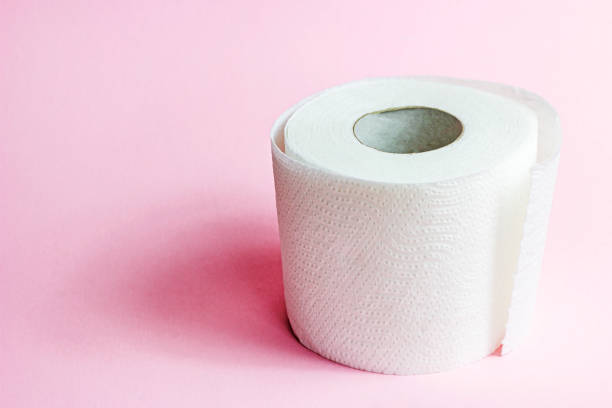 istock White toilet paper roll on light pink background with copy space 1329703614