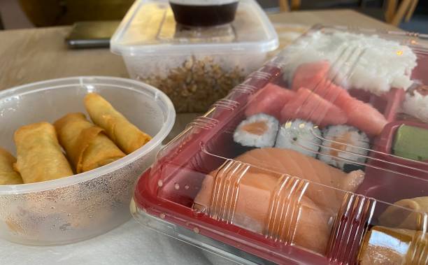 istock Sushi and spring rolls packed in plastic box to go during corona Covid-19 time 1329703846