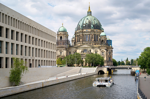 Berlin, Germany – July 15, 2021: Spree River in Berlin with newly built Humboldt Forum (Stadtschloss) and historic Berlin Cathedral