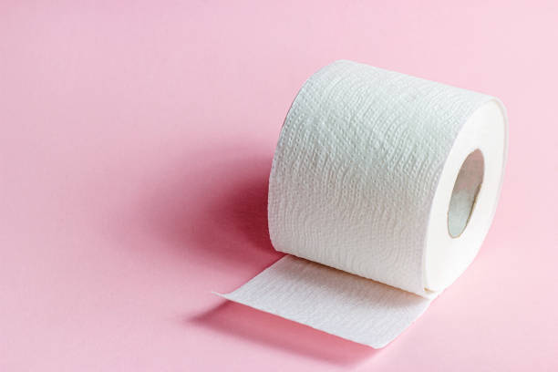 istock White toilet paper roll on light pink background with copy space 1329704898