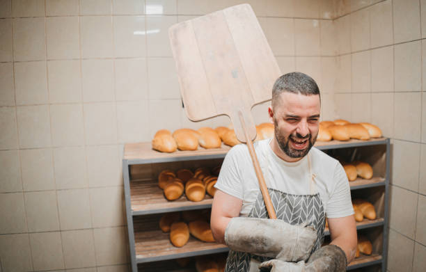 istock Baker with baked breads at the bakery 1329705944