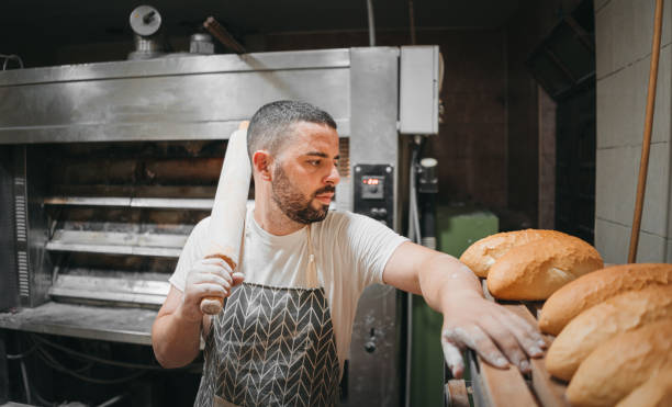 istock The baker arranges the bread in the bakery 1329706531
