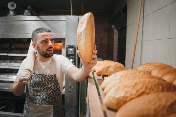 istock The baker arranges the bread in the bakery 1329706611