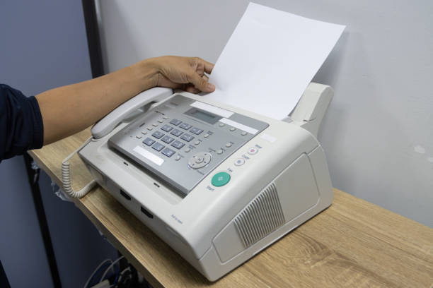 istock hand man are using a fax machine in the office, equipment for data transmission. 1329707288