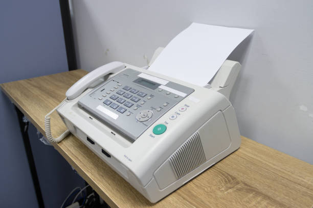 istock hand man are using a fax machine in the office, equipment for data transmission. 1329707295