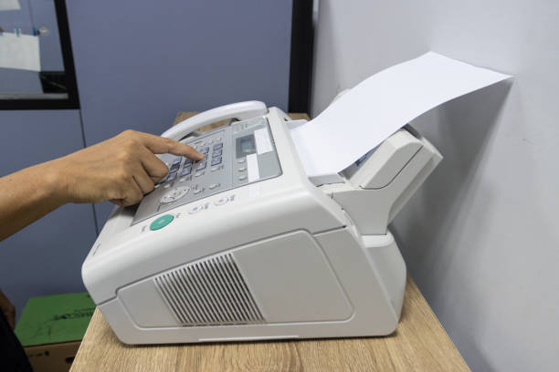istock hand man are using a fax machine in the office, equipment for data transmission. 1329707307
