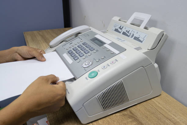 istock hand man are using a fax machine in the office, equipment for data transmission. 1329707329