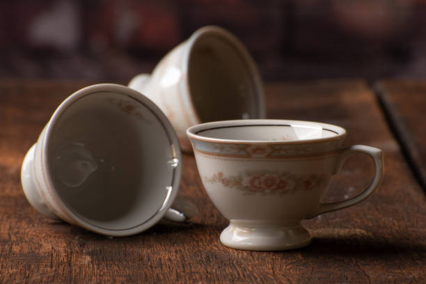 istock Porcelain cups, beautiful porcelain cups arranged on rustic wood, dark background, selective focus. 1329710227