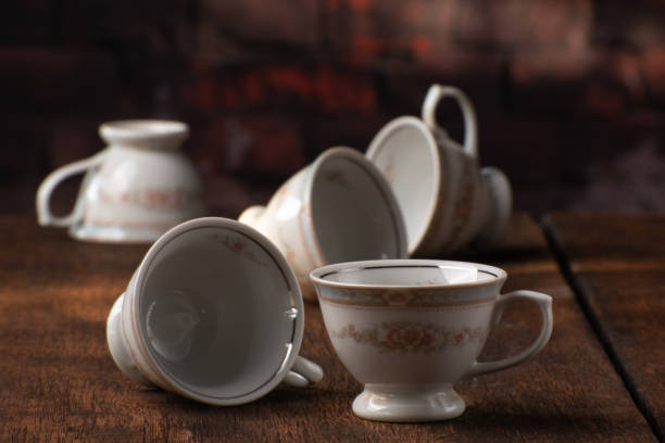 istock Porcelain cups, beautiful porcelain cups arranged on rustic wood, dark background, selective focus. 1329710290