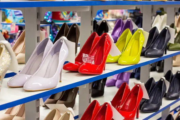 New elegant women shoes on the retail clothing shop display shelf.