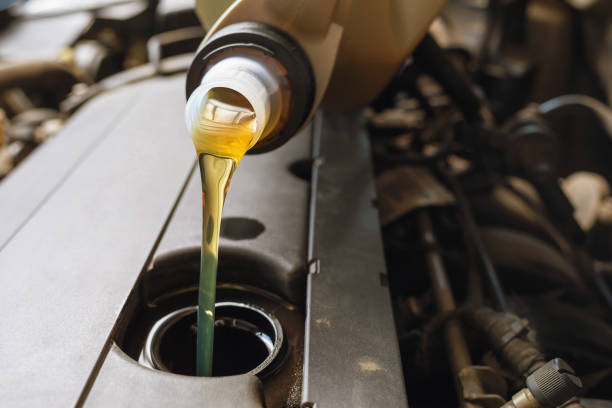 istock The process of pouring engine oil into the engine close-up 1329714308