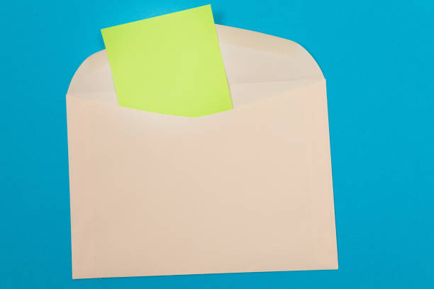 istock Beige Envelope with Blank Green Sheet of Paper Inside 1329714347