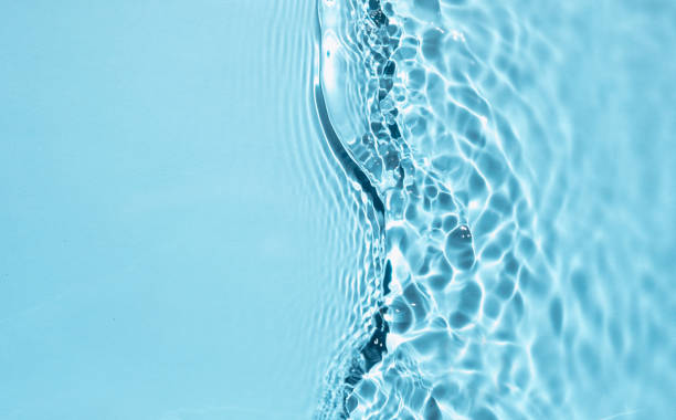 istock Summer banner background. Blue liquid colored clear water surface texture with splashes bubbles. Trendy blue nature background. Blurred or defocused transparent clear water. 1329714440