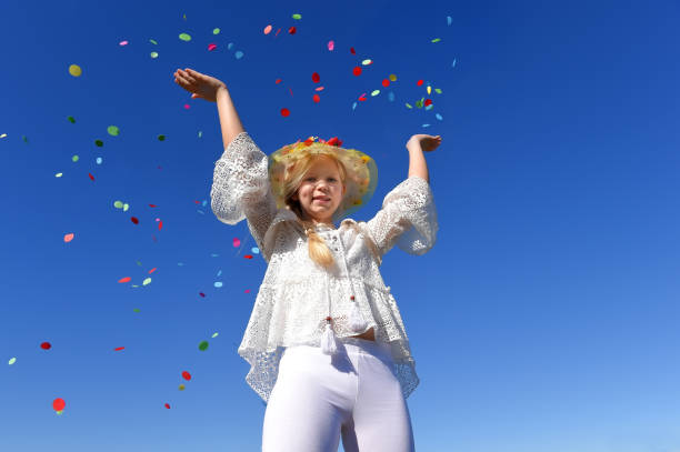 istock White Dressed Girl Throws Confetti Around 1329715241