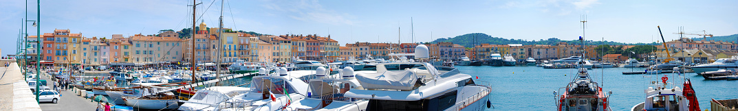 Old port of Saint Tropez with historic buildings, boats and yachts, panorama