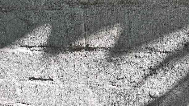 istock Old concrete wall, natural texture. Light background. The shadows. 1329716464