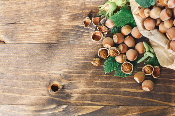 istock hazelnuts with green leaves on a wooden surface 1329716770
