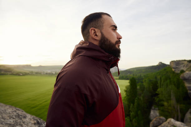 istock Young bearded man portrait outdoors in the mountains 1329717945