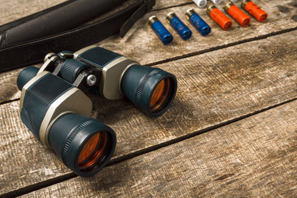 istock Hunting equipment binoculars on wooden background close up 1329719826