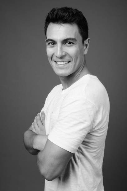 istock Young handsome Hispanic man against monochrome portrait in black and white 1329720593