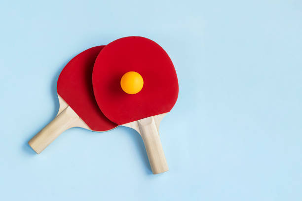 istock Two red ping pong paddles and ball 1329720788