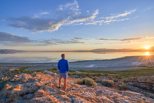 A man enjoying Sunrise of Salt Lake in the beautiful Antelope Island State Park near Salt Lake City, Utah USA.