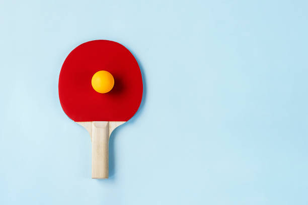 istock Red ping pong paddle and ball 1329723370
