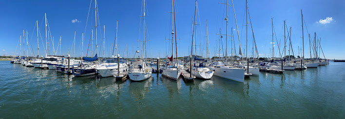 Panoramic view of yachts from water in Parkstone marina, Poole Harbour, Dorset, England, UK. Sunshine enhances summer colours on this array of yachts in panoramic image in the world's second largest natural harbour at Poole, Dorset, England, UK