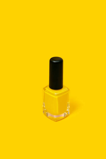 istock yellow nail polish isolated on yellow background with copy space 1329724398