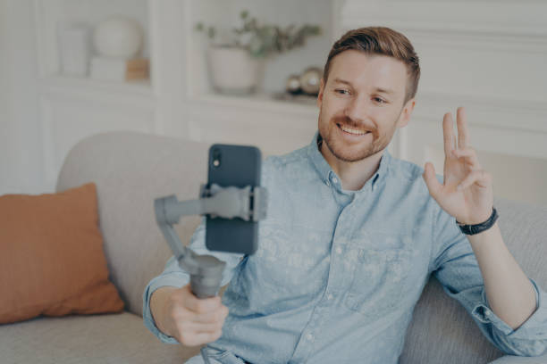 istock Young man talking with his friend through online video chat using telephone 1329726159