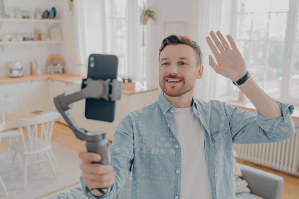 istock Young handsome guy blogger making video blog on smartphone 1329727111