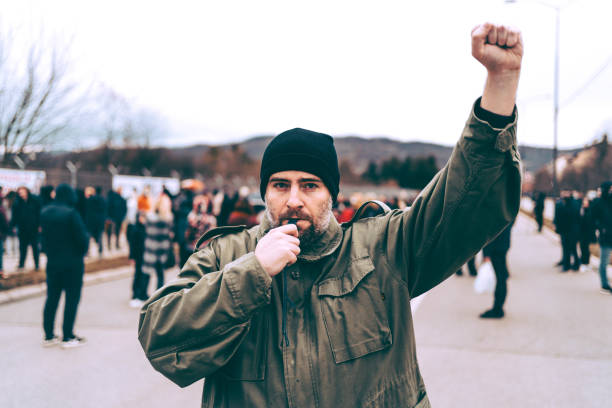 istock Man protester raising his fist up 1329727274