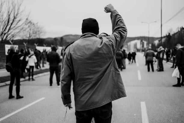 istock Man protester raising his fist up 1329727565