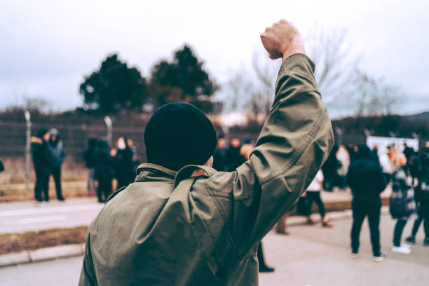 istock Man protester raising his fist up 1329727704