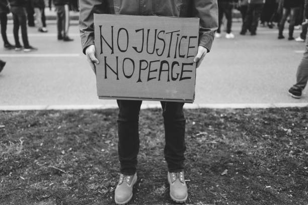 istock Man protester holding placard 1329727760