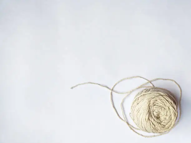 Spool of yarn on the corner with copy space on white background