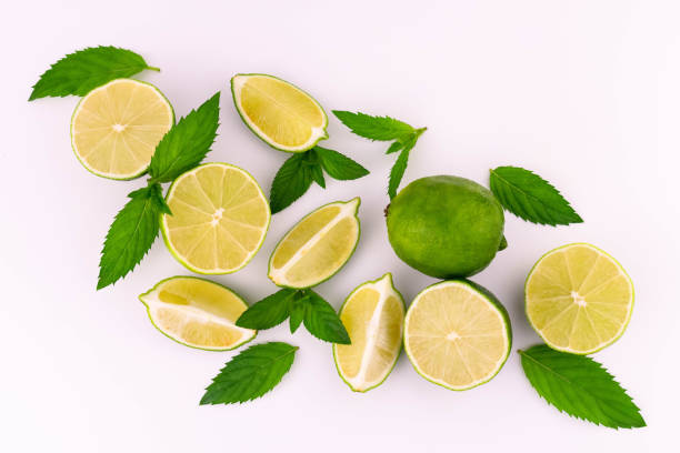 istock Limes and mint on a white background. View from above. 1329729013