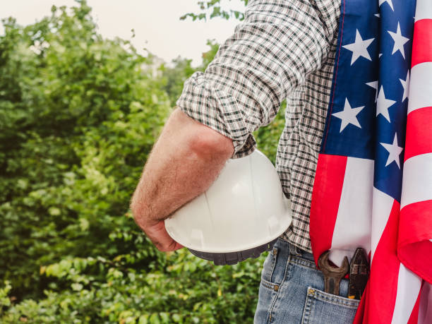 istock Attractive man holding construction helmet in his hands 1329732579