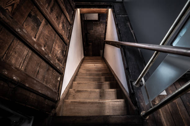 istock Old wooden stairs going down to a basement 1329734334
