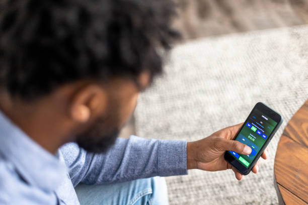 istock Young black man trading stocks on app 1329737076