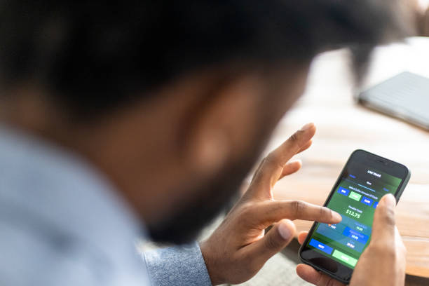 istock Young black man trading stocks on app 1329737122