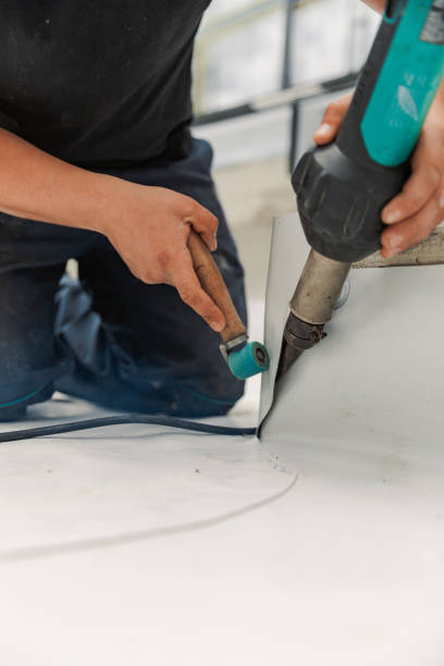 istock Worker specialized in mounting PVC membranes, TPO in the process of installing a water resistant 1329737143
