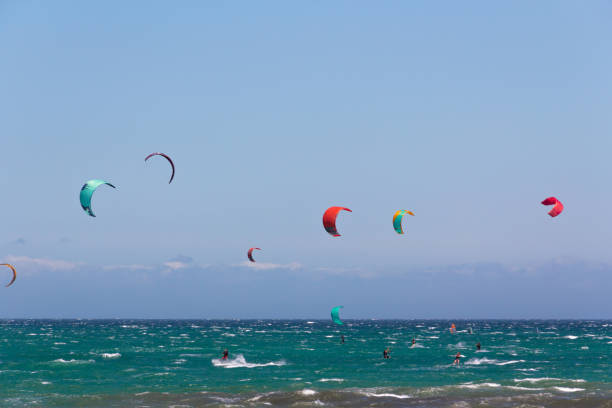 istock Seascape with people practicing kitesurfing. Sea sport. 1329737917
