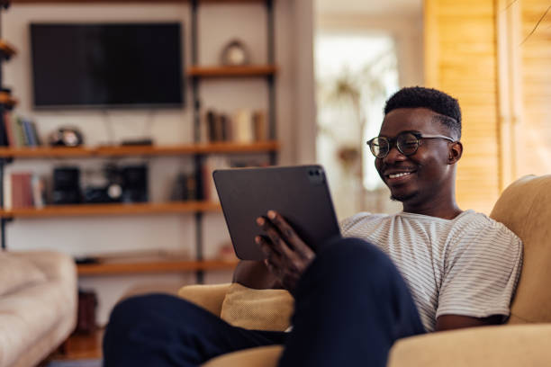 istock African man, enjoying his hobbies, at home. 1329742027