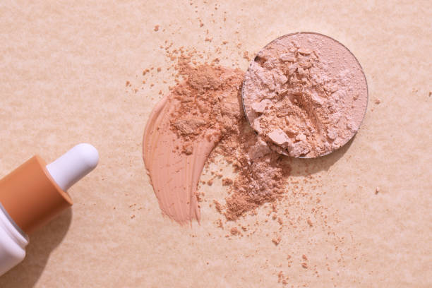 istock Crashed beige face finishing and liquid powder. Macro texture of make-up on beige background 1329744046