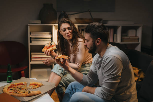 istock friends couple at home 1329745339