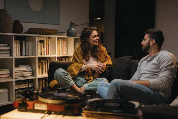 istock friends couple at home 1329745342