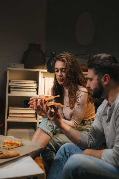 istock friends couple at home 1329745418