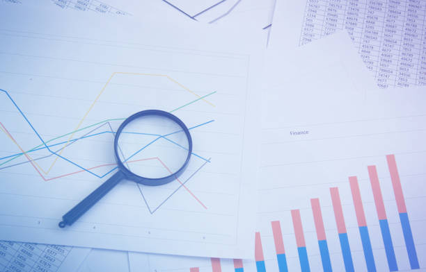 istock Magnifying glass on charts, graphs and financial statements. Inventory chart analysis and financial accounting. Copy space. Can be used for presentations 1329749311