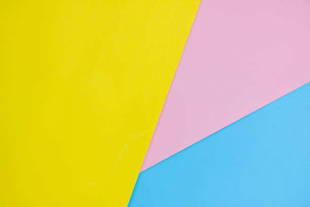 istock Abstract yellow, pink and blue paper background. 1329749322